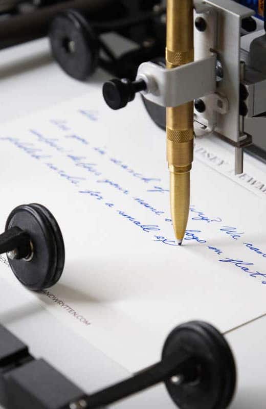 handwrytten robot writing message in ballpoint pen
