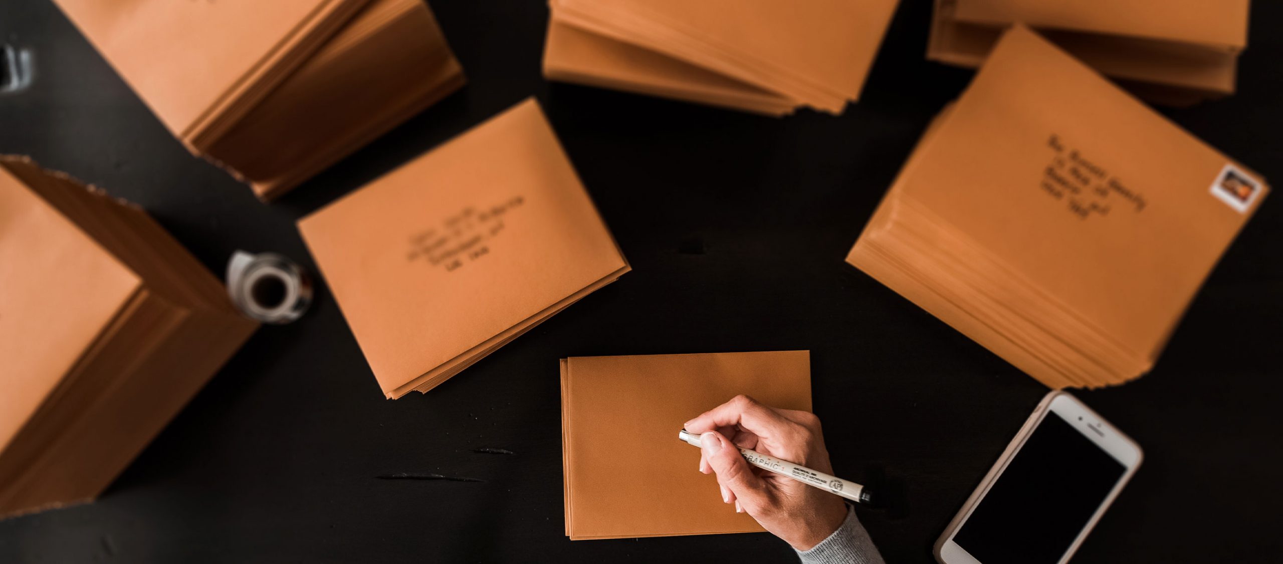 woman handwriting envelopes